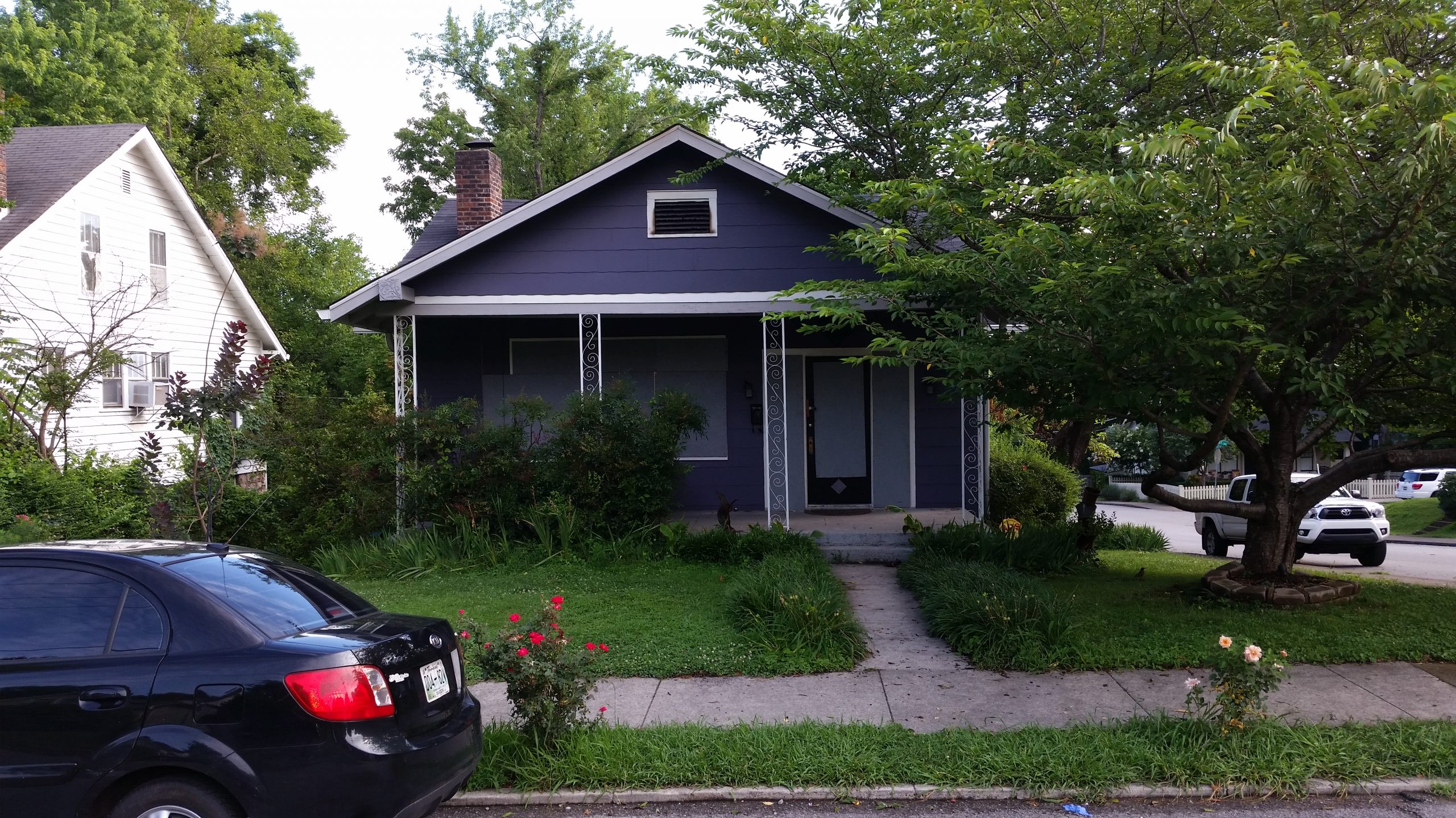 Front of a blue bungalow style house after a fire damage