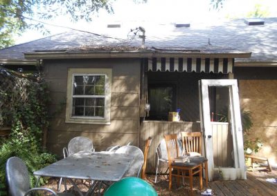 Back of a fire damaged house with debris everywhere