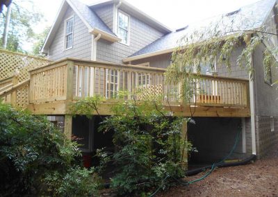 New wood deck built onto the back of a house after a fire