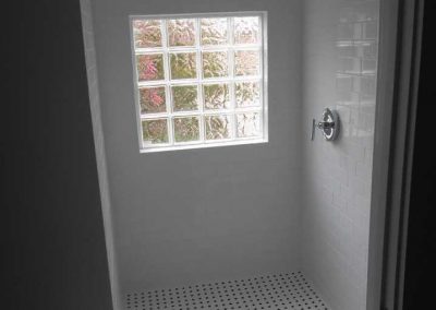 Renovated shower with new tile after a file damage