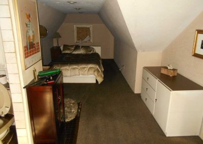 Guest bedroom in an attic after a fire damage