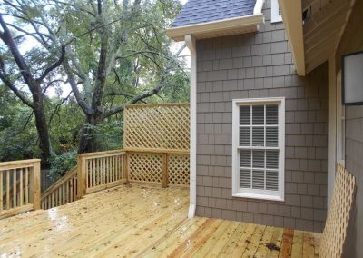 New wood deck on the back of a house that was damaged by fire