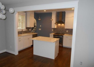 New kitchen island and white cabinets after a fire destroyed this kitchen