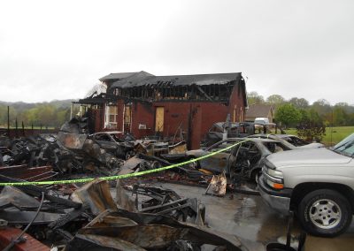 Front of a red brick house destroyed by a fire