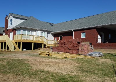 Brick garage carport and wood deck that were rebuilt by Blue Chip Restoration after a fire destroyed them