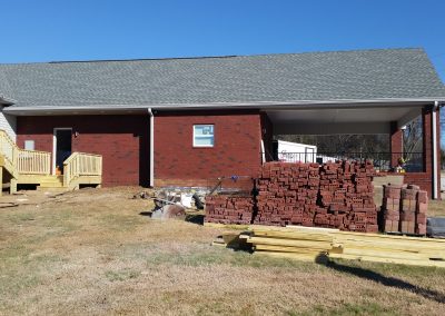 Blue Chip Restoration inspects a rebuilt brick garage and carport after a fire destroyed it