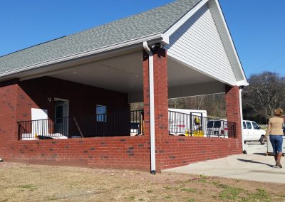 Blue Chip Restoration inspecting a rebuilt brick carport that was destroyed by fire