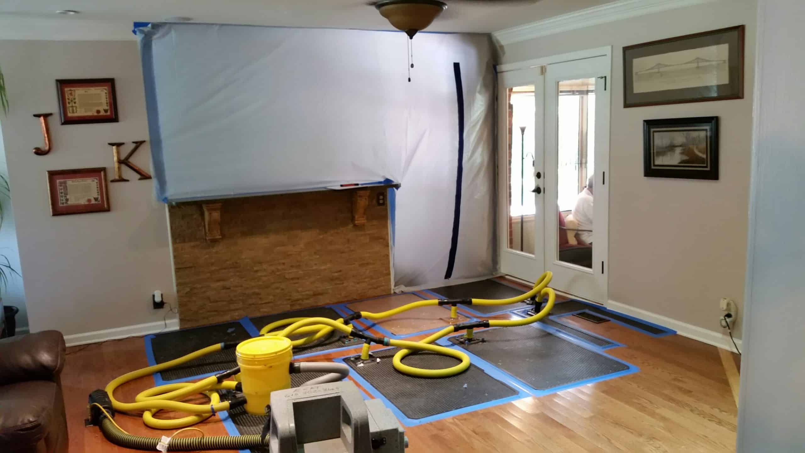 Nashville water damage restoration by Blue Chip Restoration using an air scrubber and plastic containment to dry a ceiling.