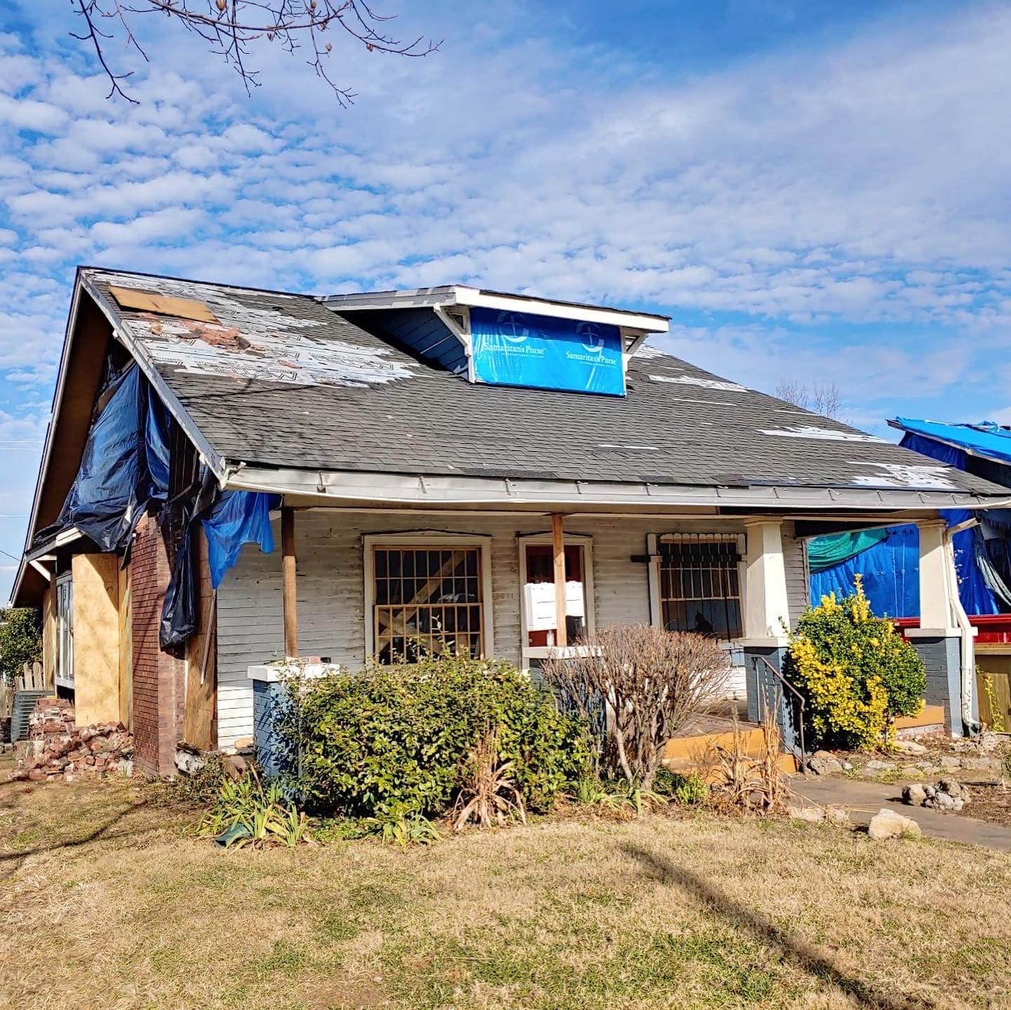 Home with storm damage repairs in progress, emphasizing the need for professional restoration.